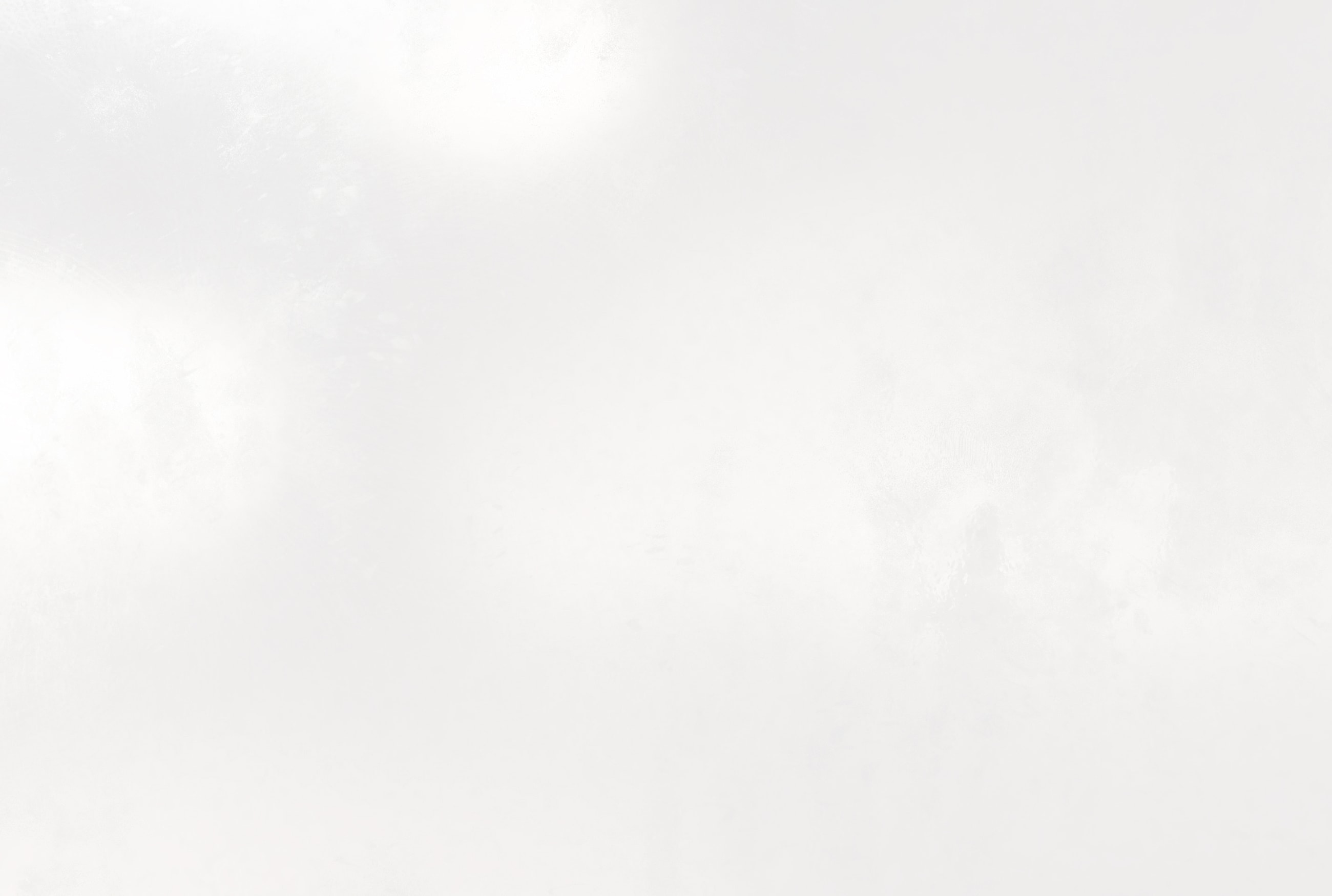 Abstract white background with subtle textures.
